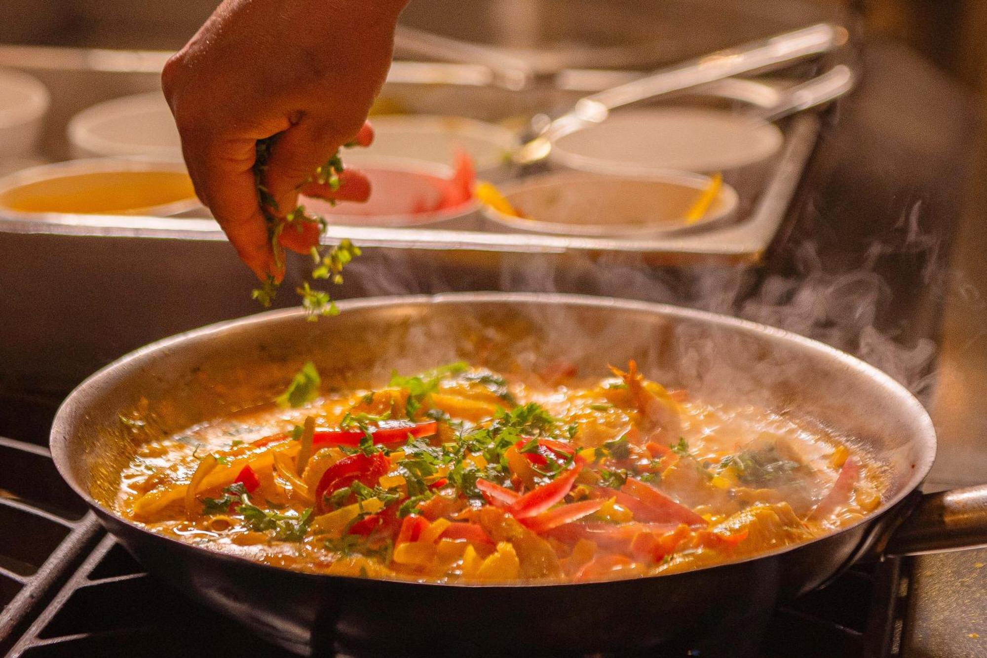 Hotel Deville Prime Salvador Ngoại thất bức ảnh A chef seasoning a dish